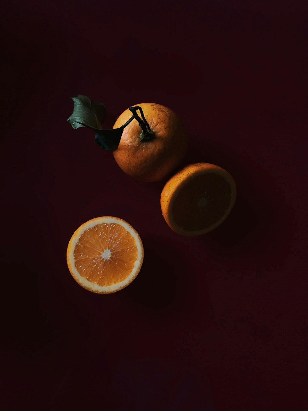 sliced orange fruit on brown surface