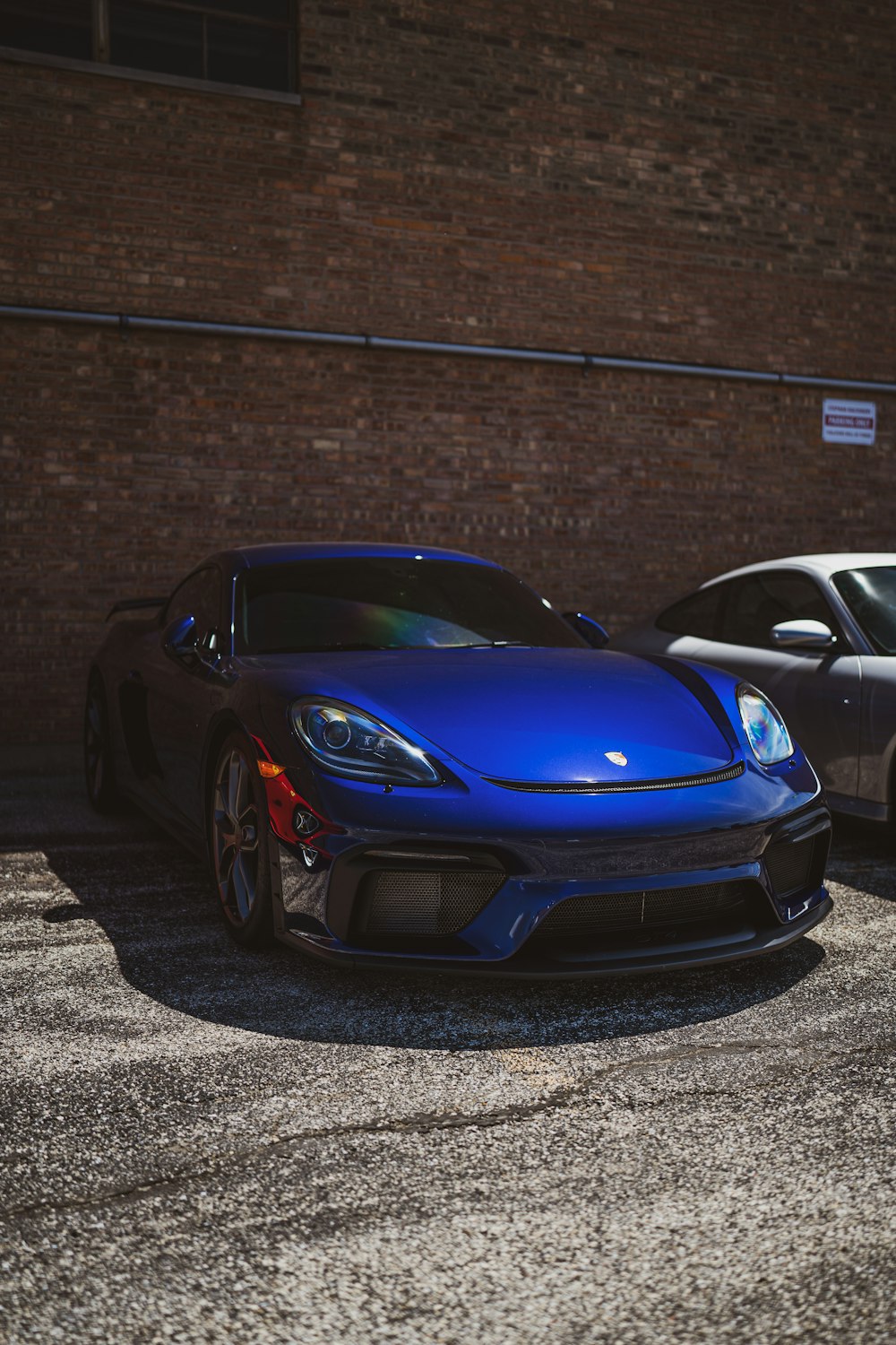 blue porsche 911 parked on road during daytime