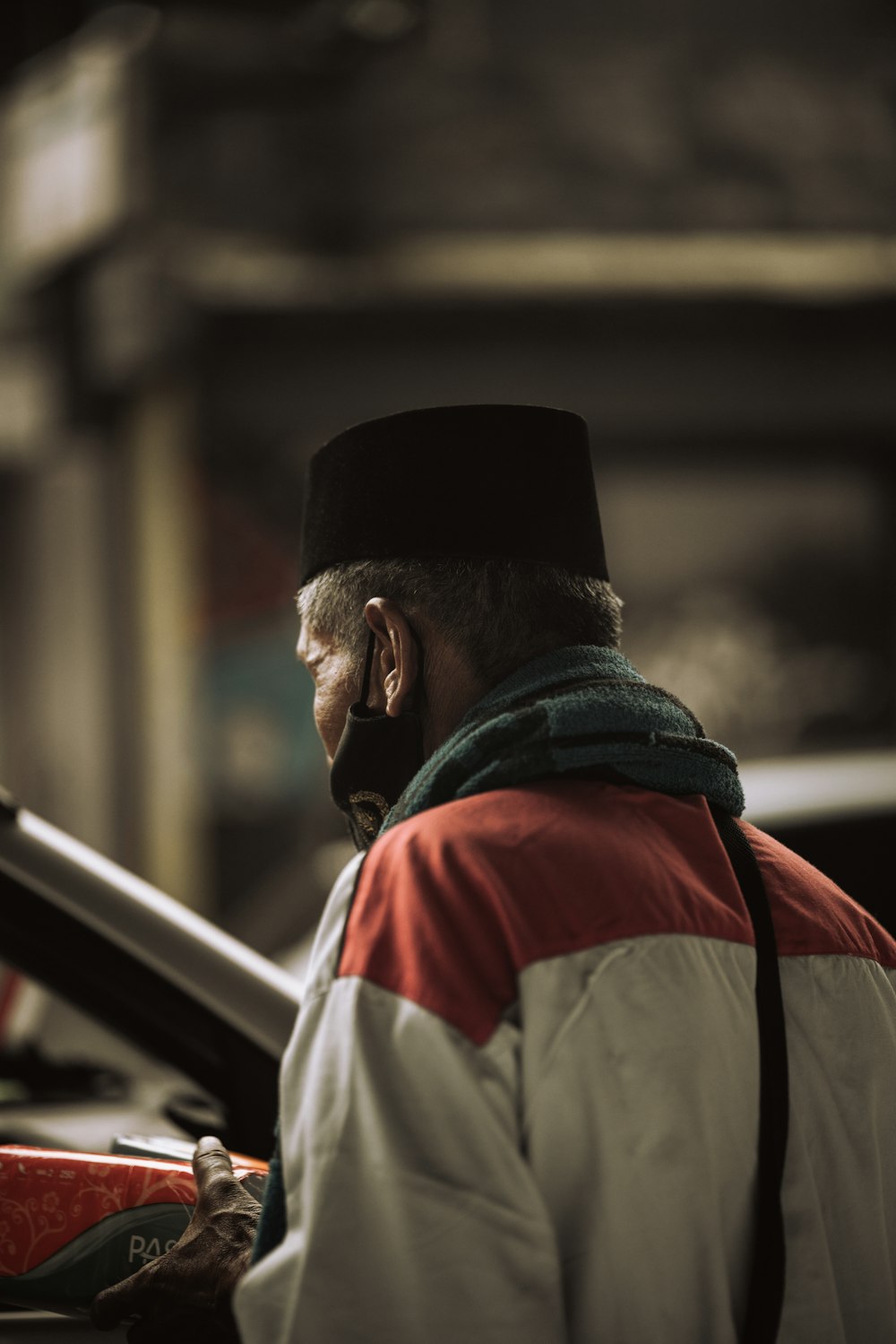 man in white and red shirt wearing black knit cap