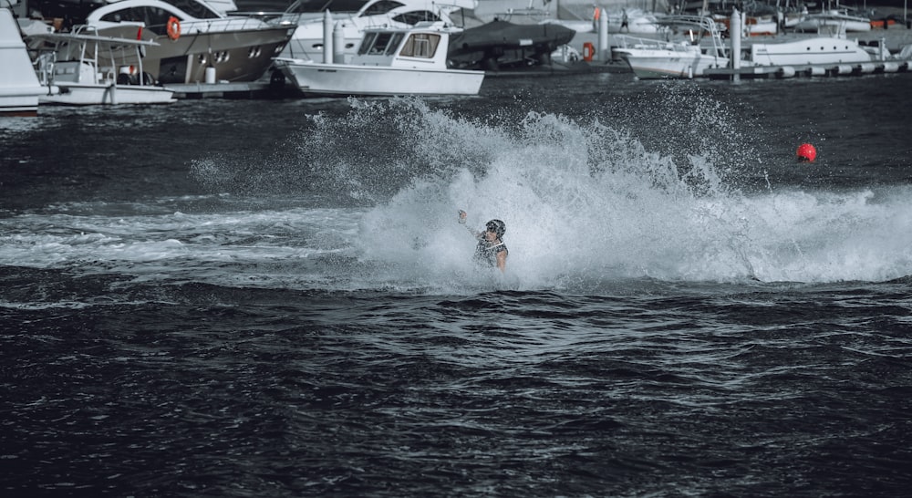 a man riding a wave on top of a surfboard