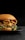 A gourmet hamburger is placed on a black plate, featuring layers of melted cheese, crispy bacon, fresh green lettuce, and a succulent beef patty, all encased in a glossy brioche bun. The background is dark, highlighting the appetizing colors and textures of the burger.