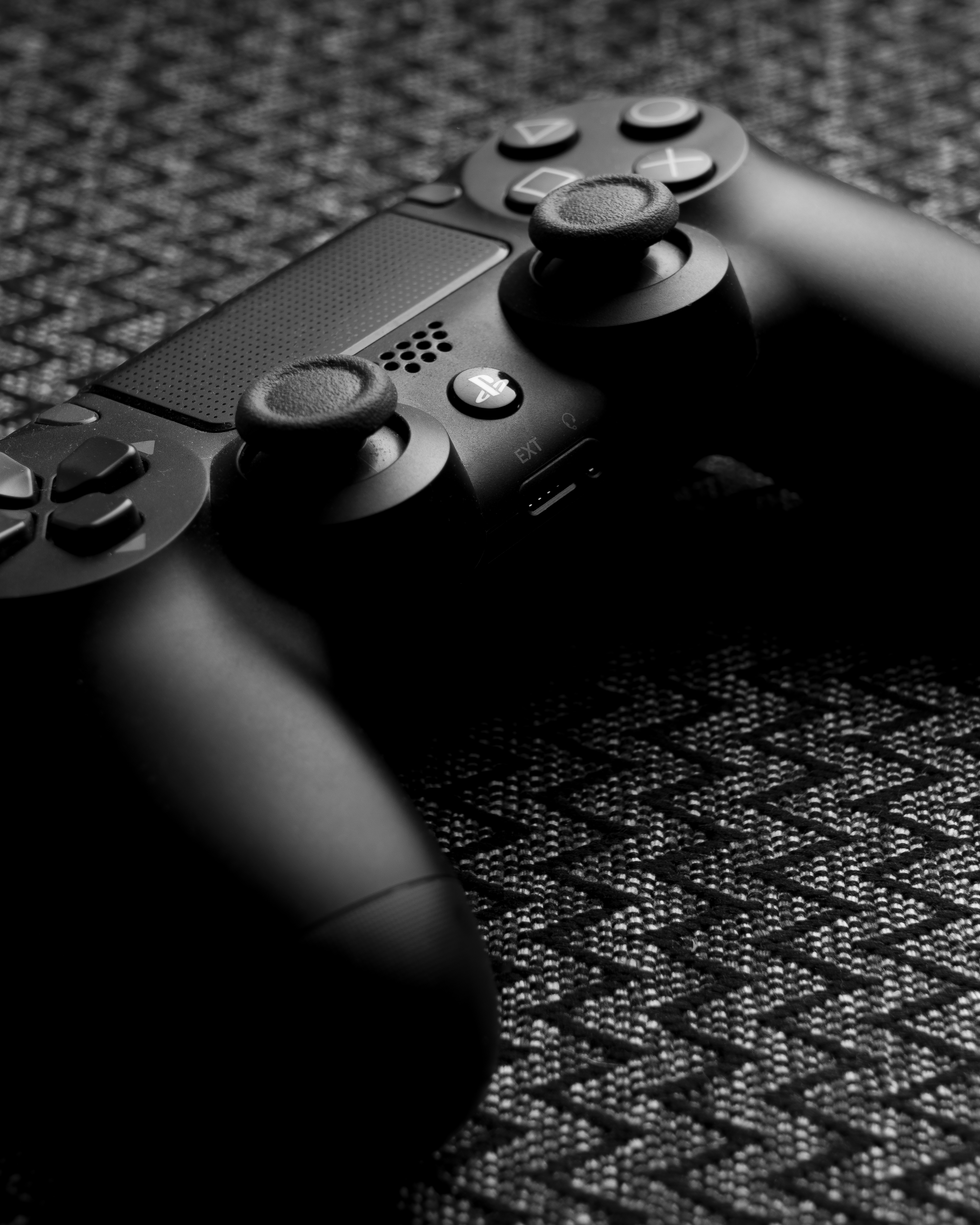 black-sony-ps-4-game-controller-photo-free-person-image-on-unsplash