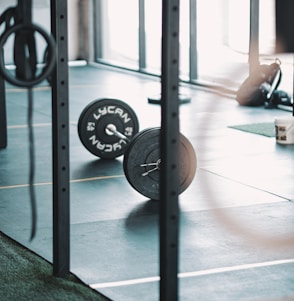 a gym with a barbell and weight plates