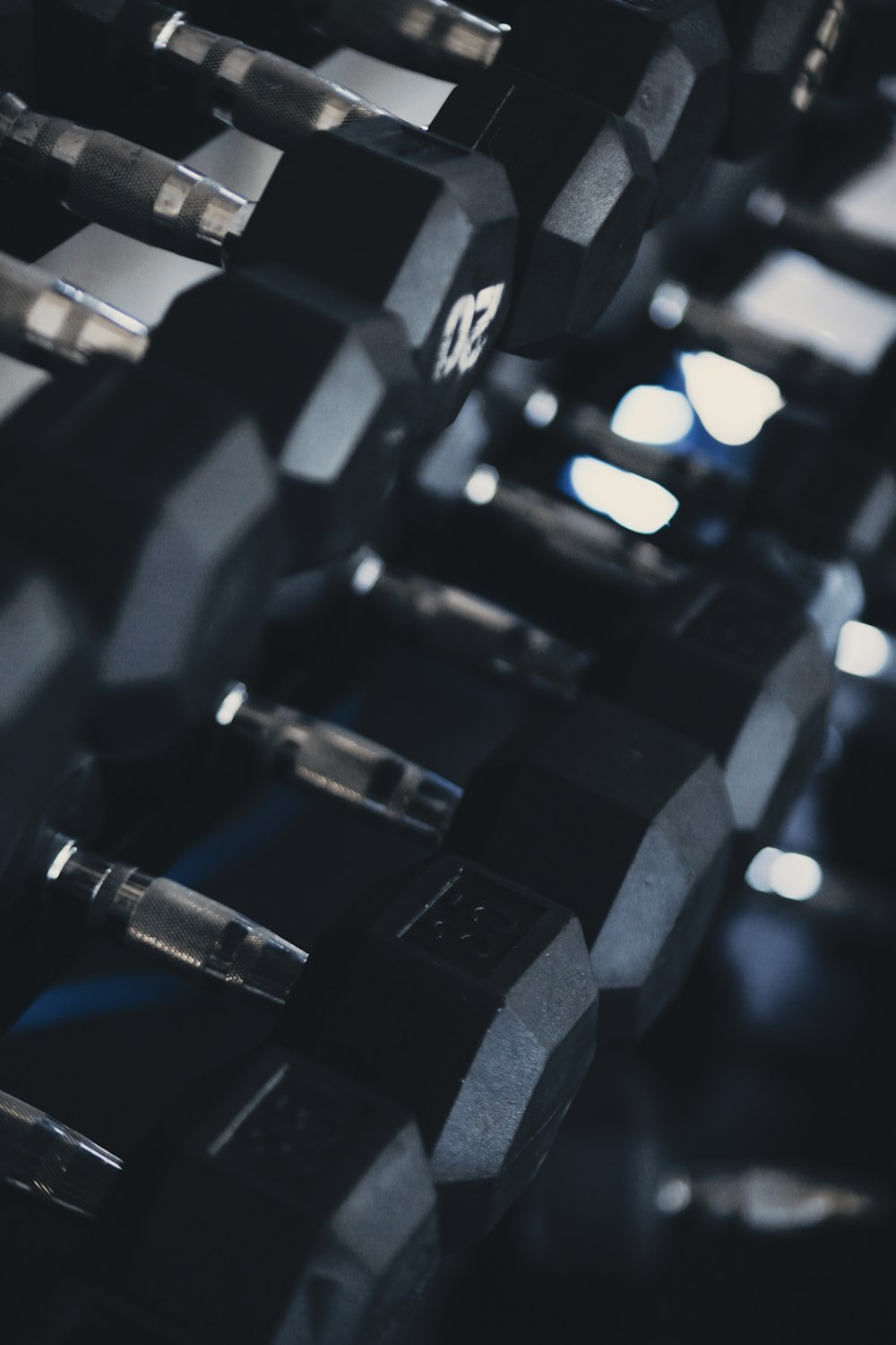 black dumbbells on black metal rack