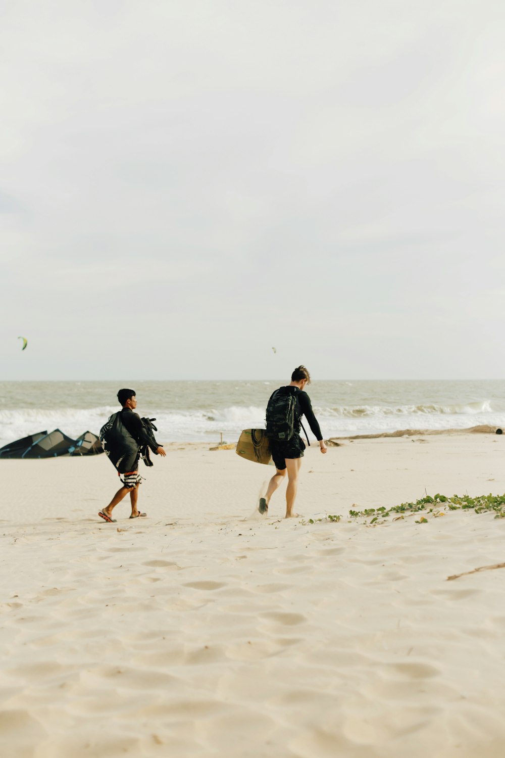 man in black shirt walking on beach during daytime