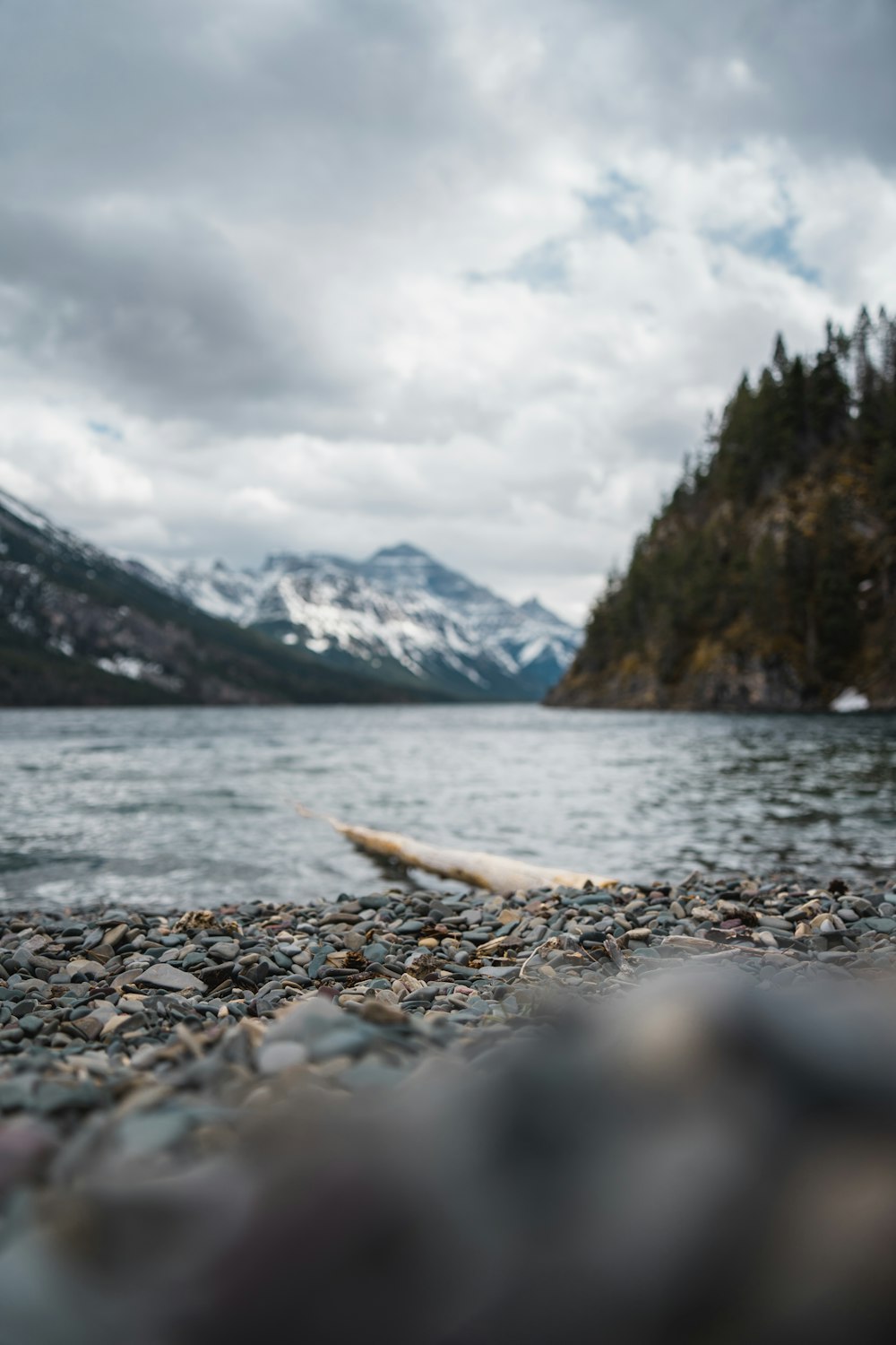 body of water near mountain during daytime