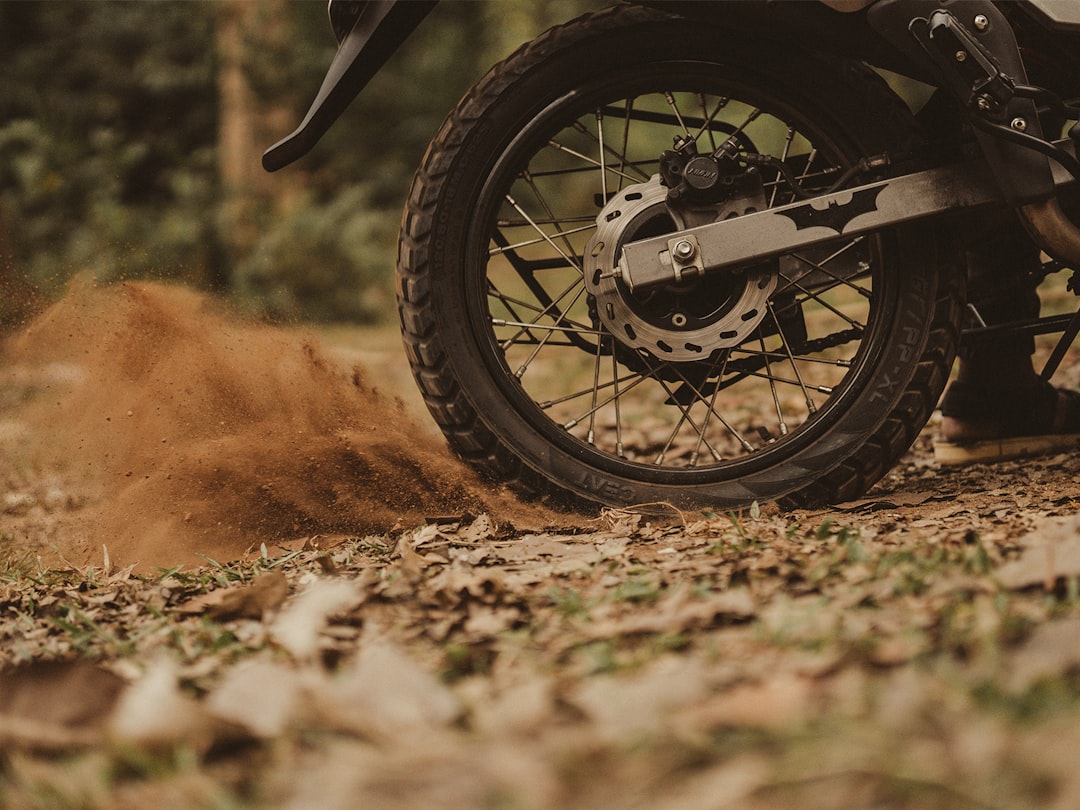 black motorcycle wheel on brown dirt road