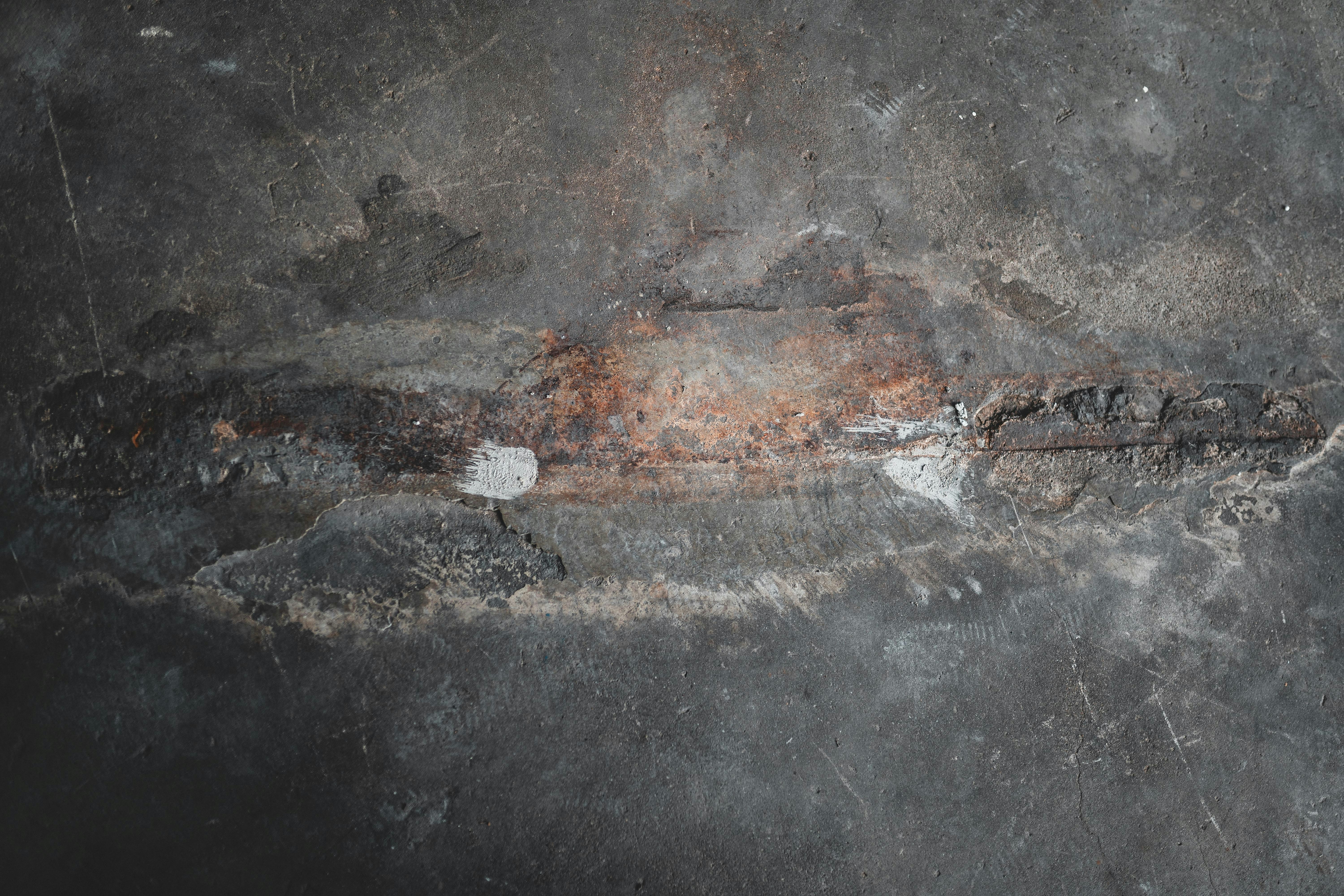 brown metal rod on black concrete floor