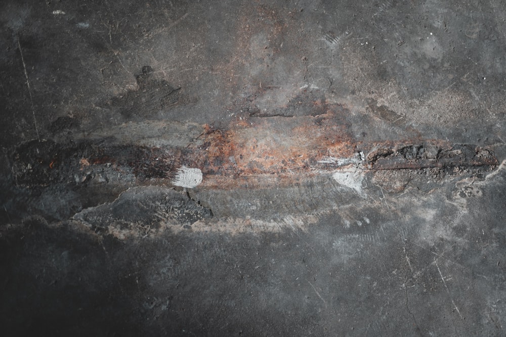 brown metal rod on black concrete floor