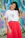 woman in white crew neck t-shirt and red skirt