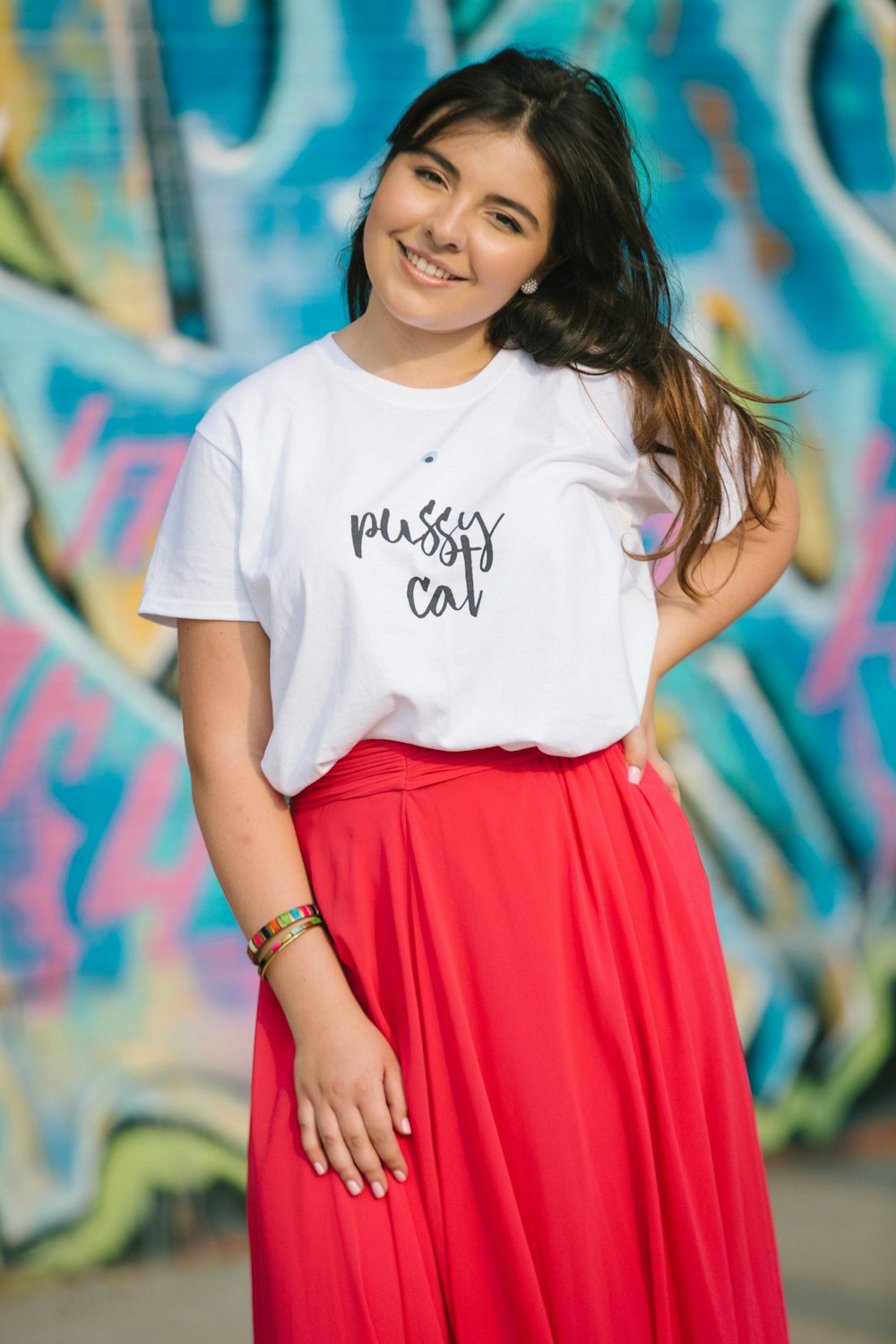 woman in white crew neck t-shirt and red skirt