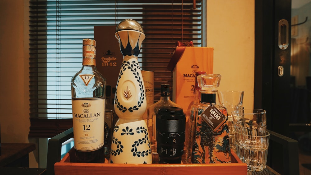 assorted glass bottles on brown wooden shelf