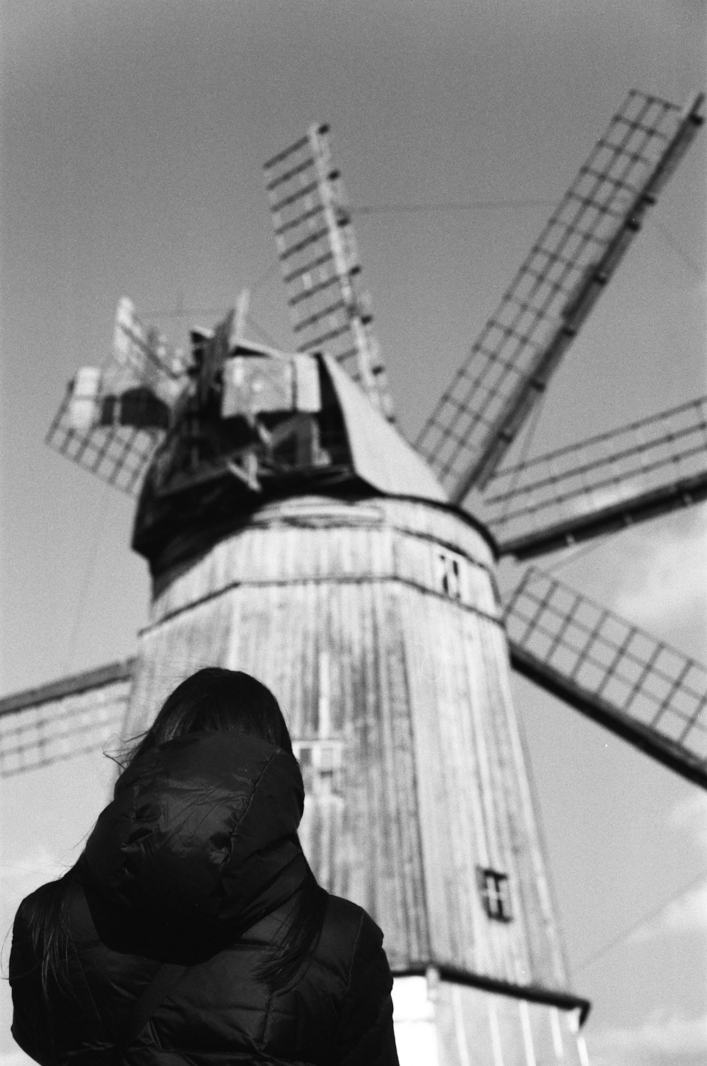 grayscale photo of person standing on top of building