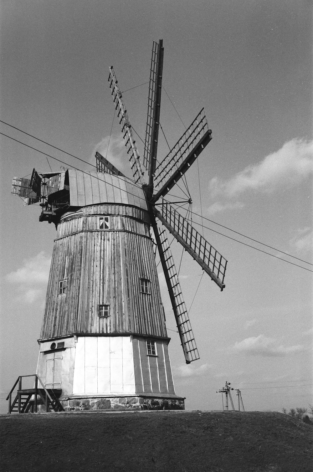 black and white windmill under cloudy sky