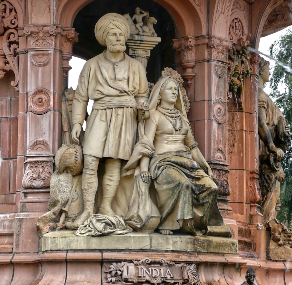 gold statue of man and woman