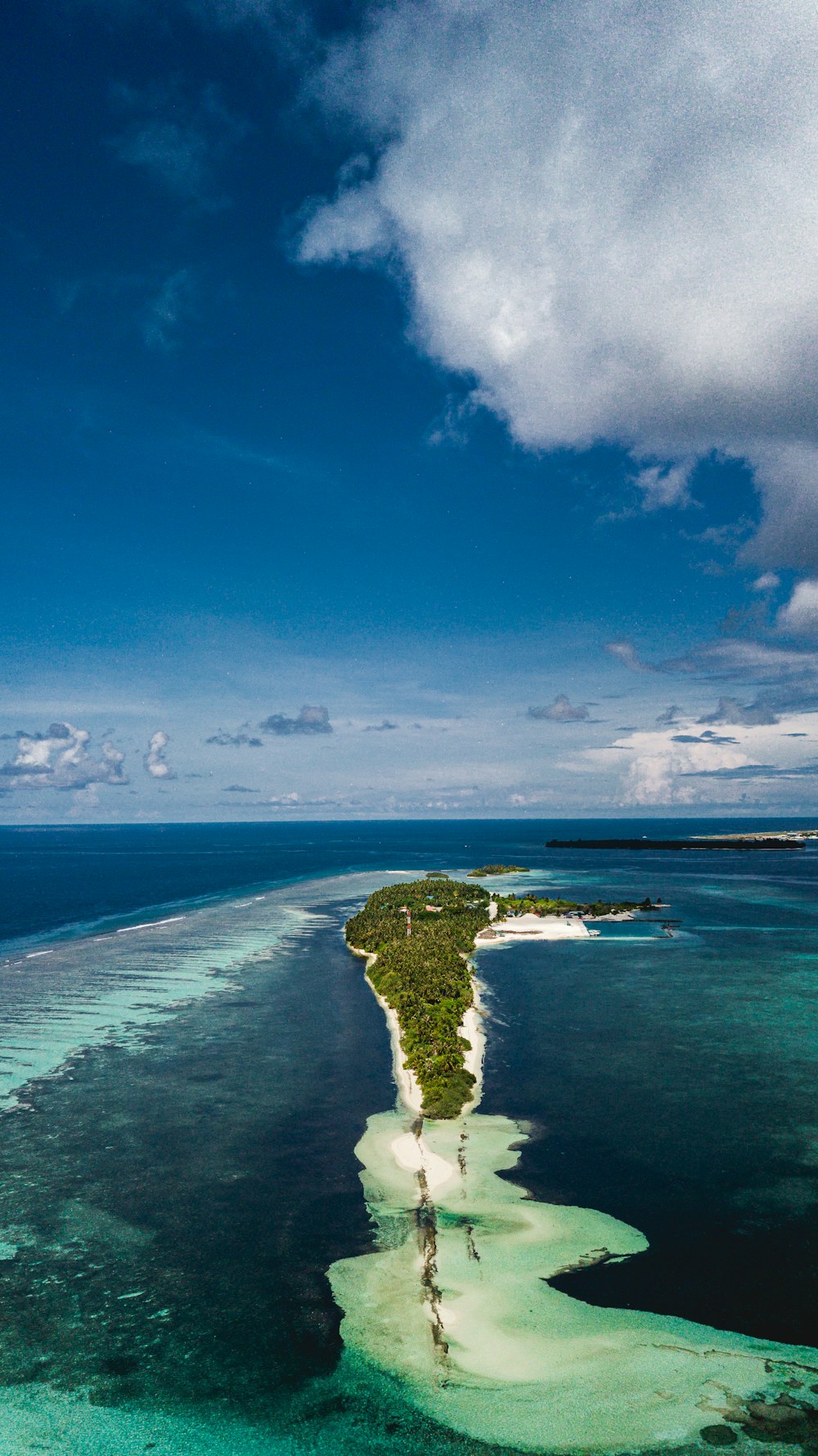 green island under blue sky during daytime