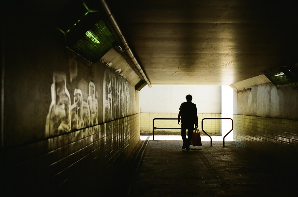 silhouette of man walking on hallway