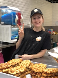 Friendly staff member smiling and serving customers