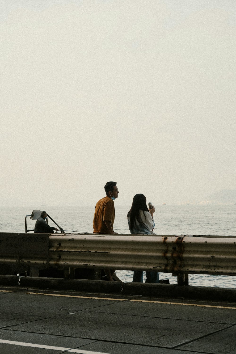 man and woman sitting on wooden dock during daytime