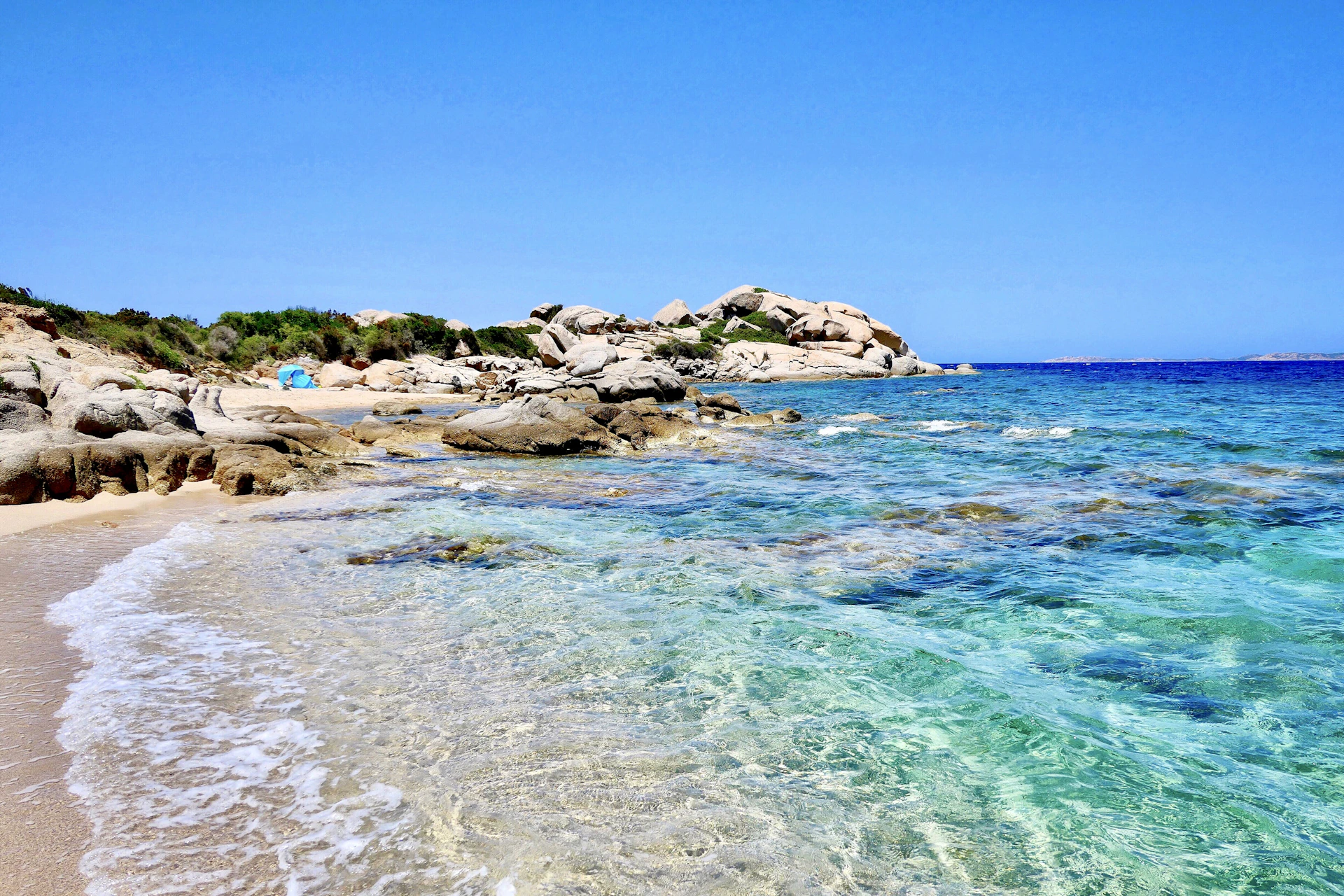 brown rocky shore under blue sky during daytime