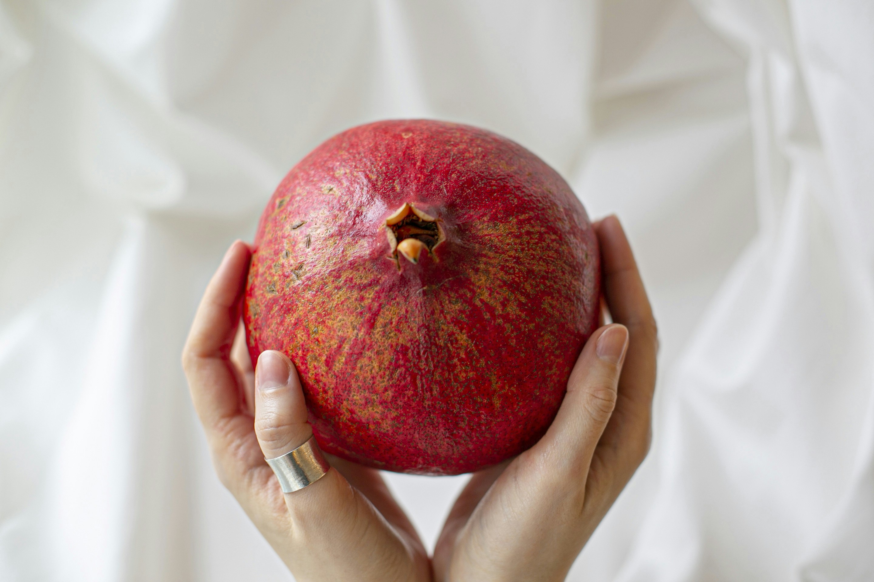 person holding red apple fruit