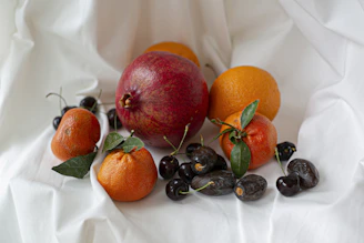A colorful assortment of ripe fruits arranged artfully on a natural linen cloth.