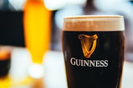 a glass of beer sitting on top of a table