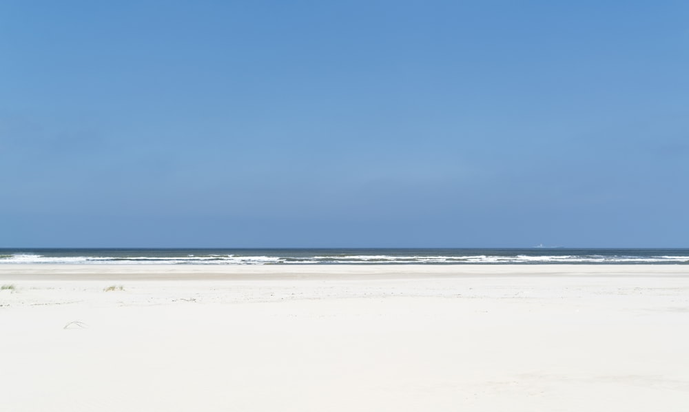 white sand beach under blue sky during daytime