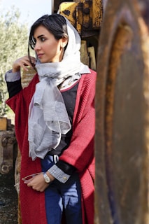 A woman wearing a stylish cardigan in a park setting.