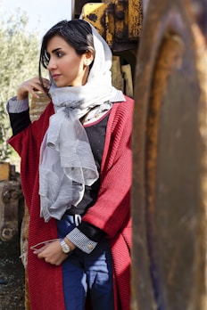 A woman wearing a stylish cardigan in a park setting.
