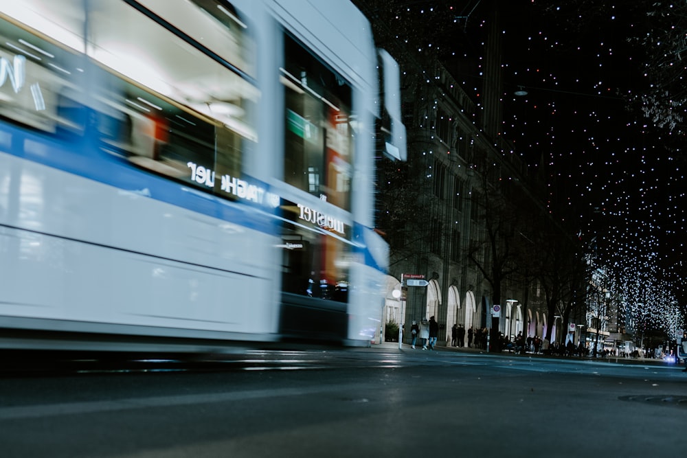 white bus on road during night time