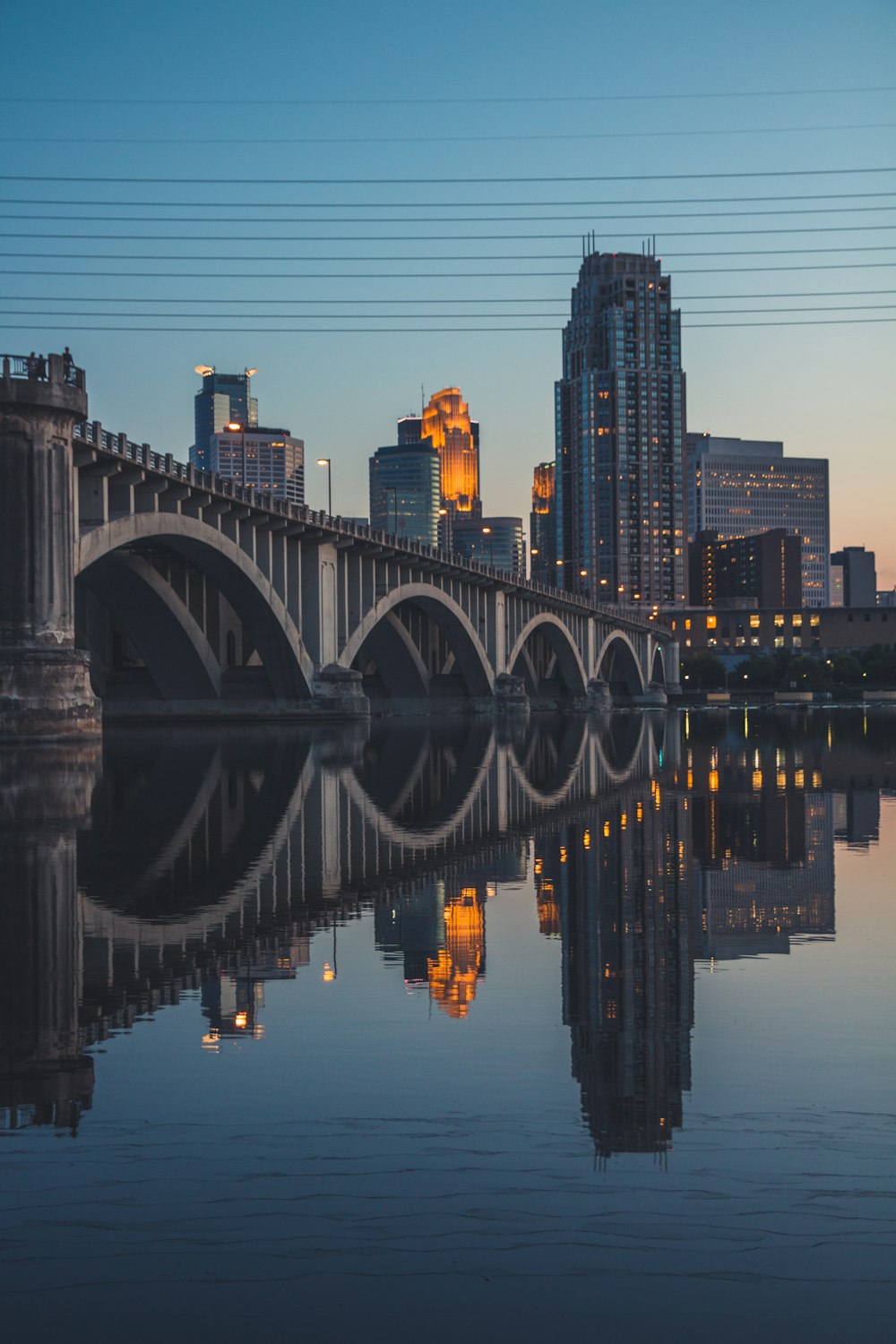 gray concrete bridge over body of water during night time