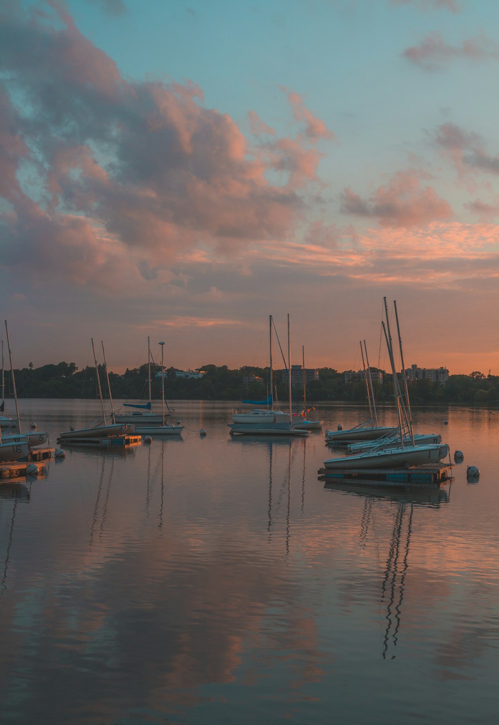 a group of boats floating on top of a lake