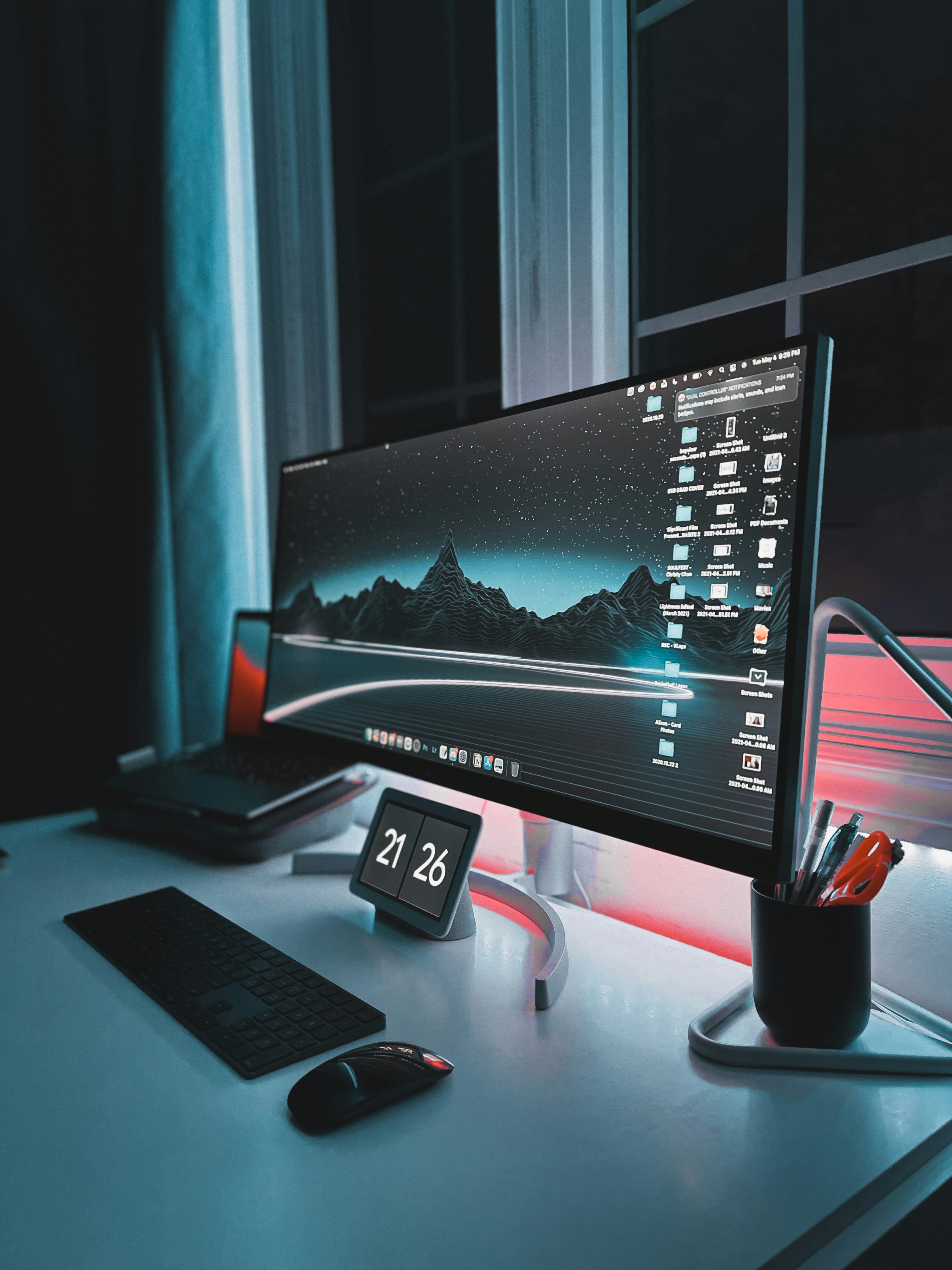 Modern electronics including laptops and smart devices on a clean desk, bright airy well-lit environment