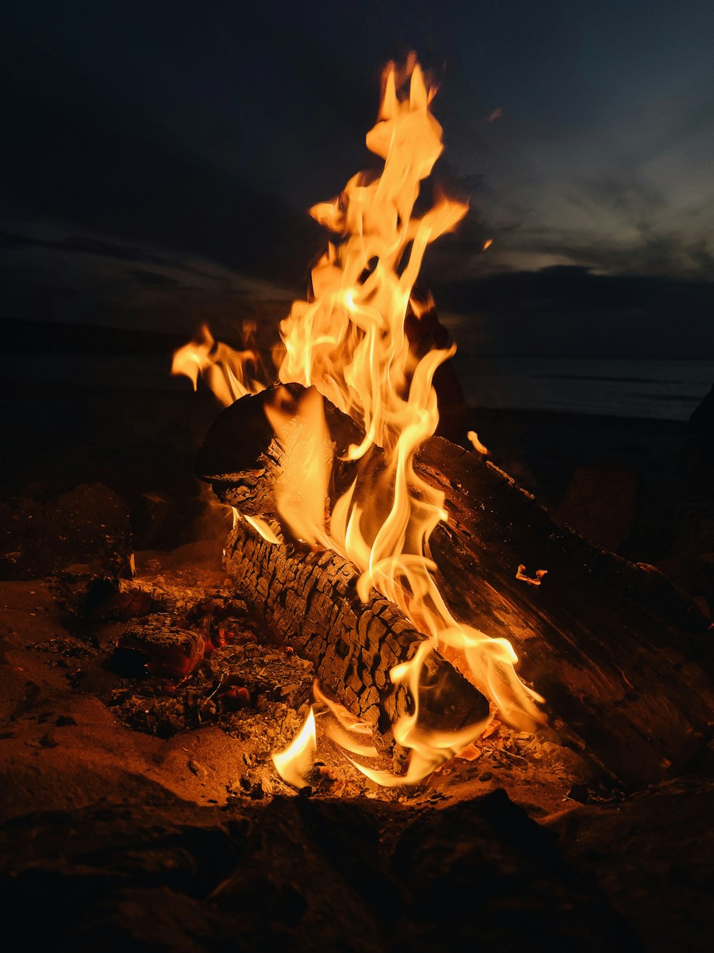 fire on brown rock during night time