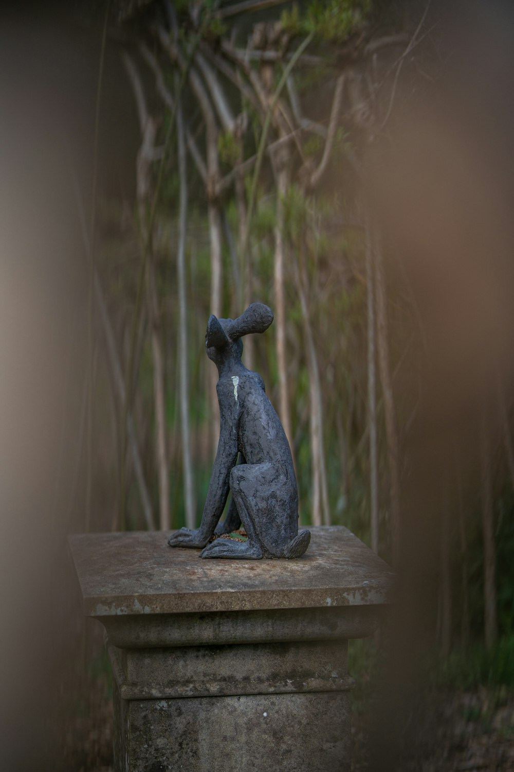 black figurine on brown wooden table