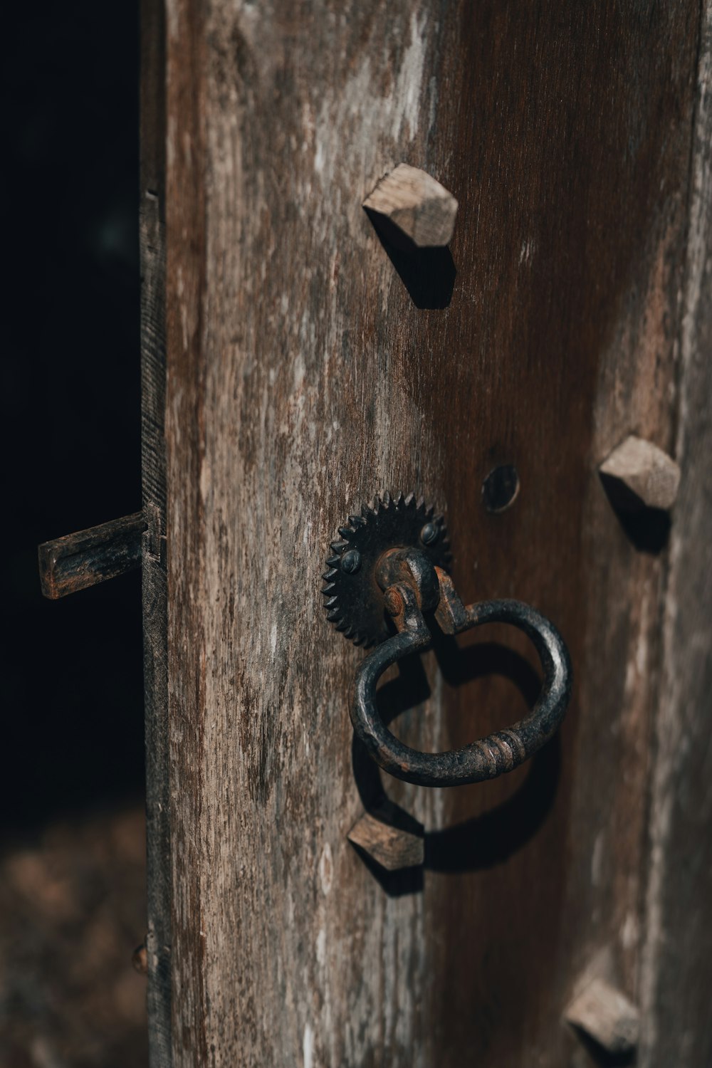 black metal hook on brown wooden surface