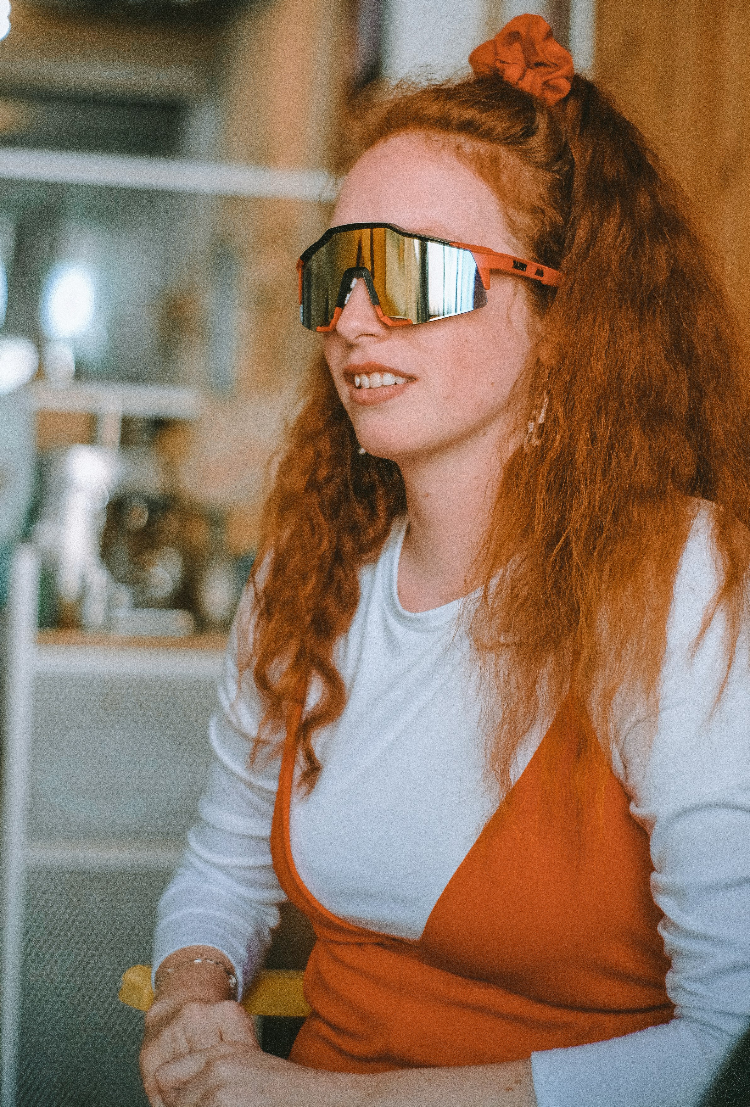 woman in white and orange long sleeve shirt wearing black framed eyeglasses