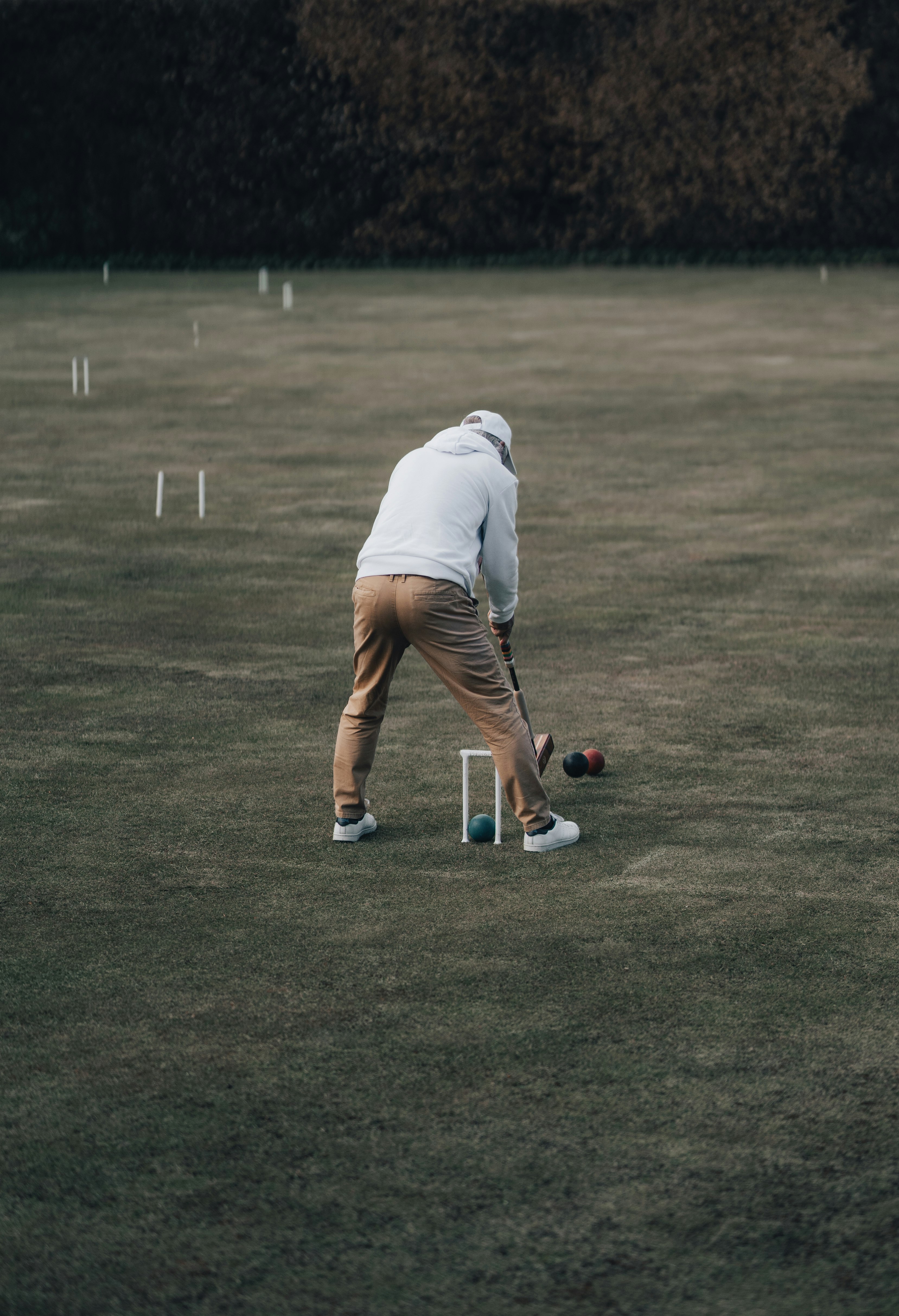 man in white t-shirt playing golf during daytime