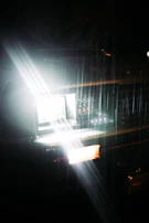 A bright, clear headlight illuminating a dark road.