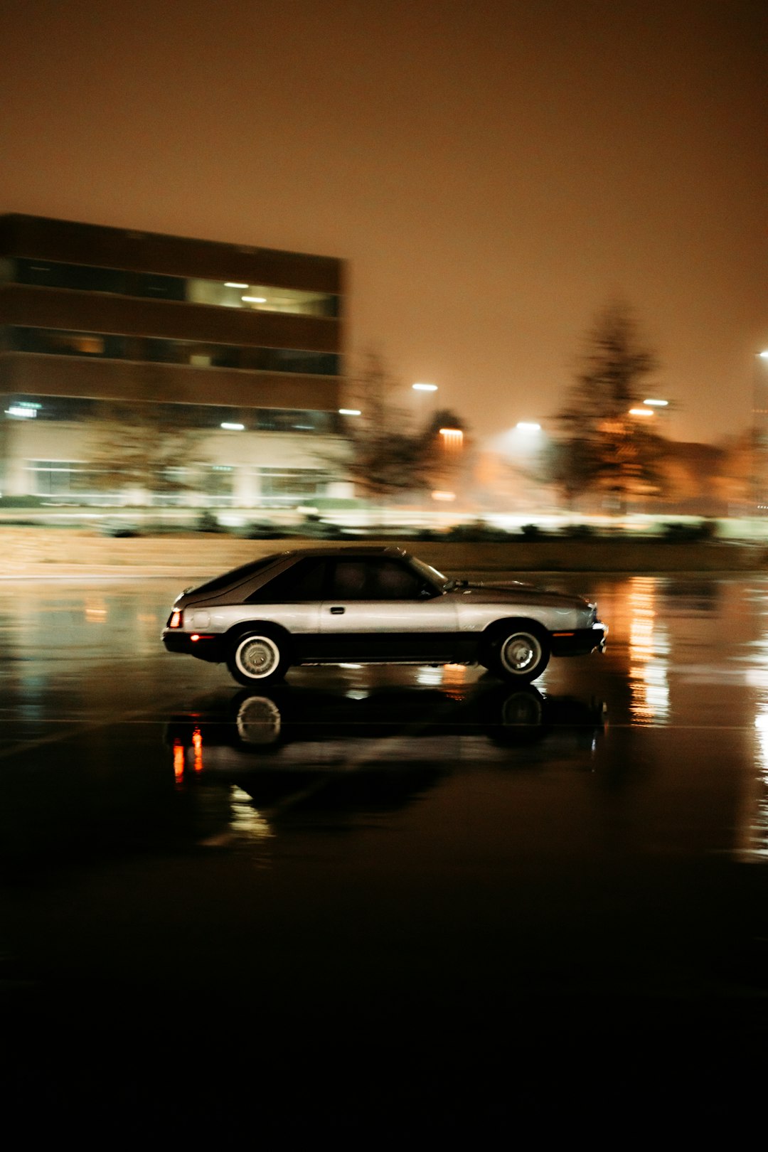 black car on road during night time