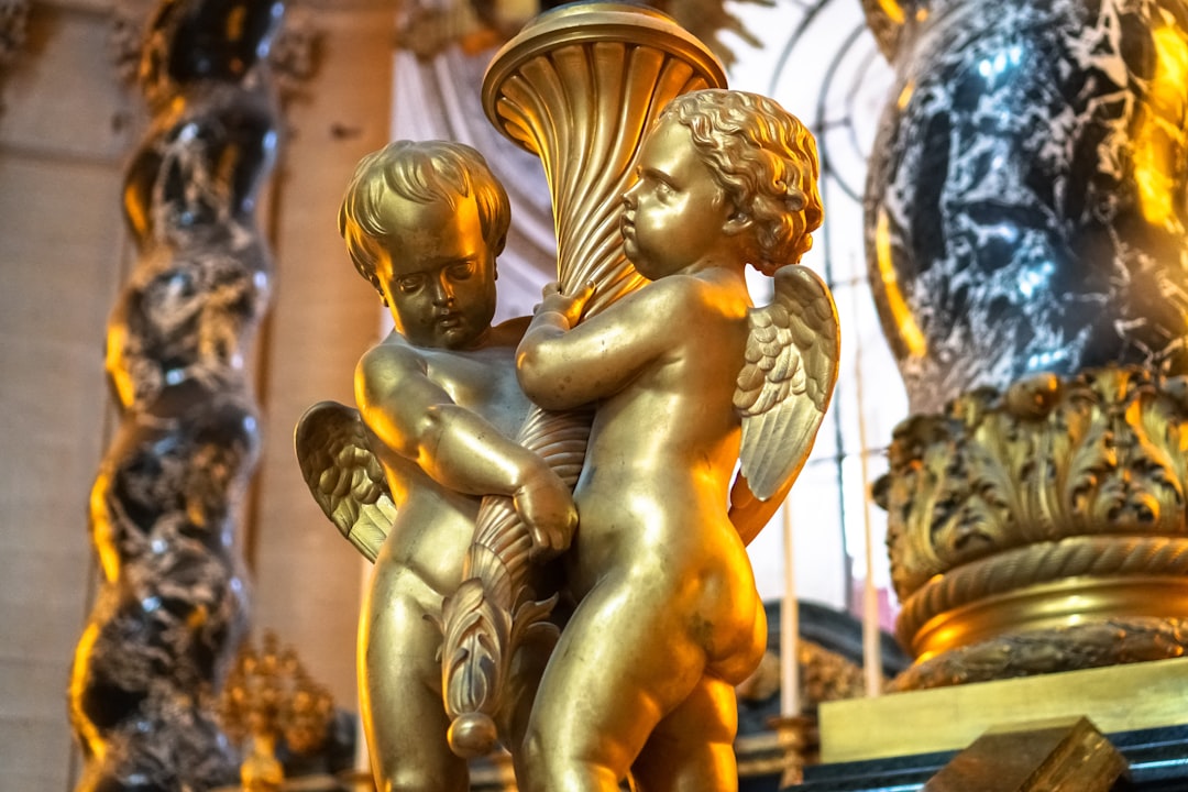 gold angel statue in close up photography
