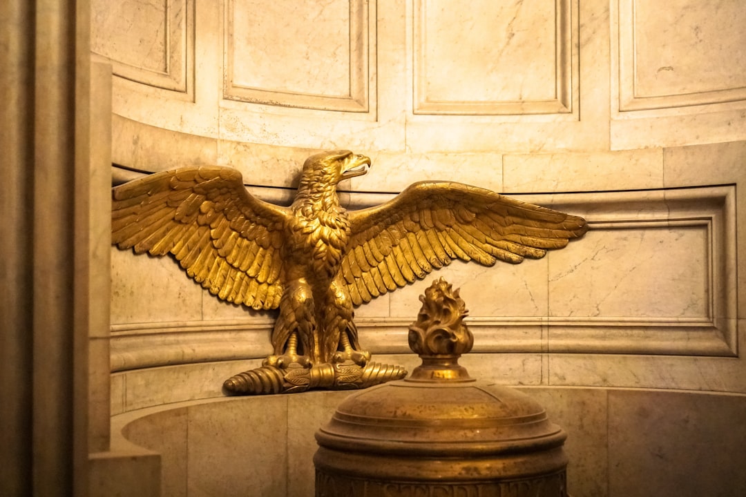 gold eagle statue on brown concrete column