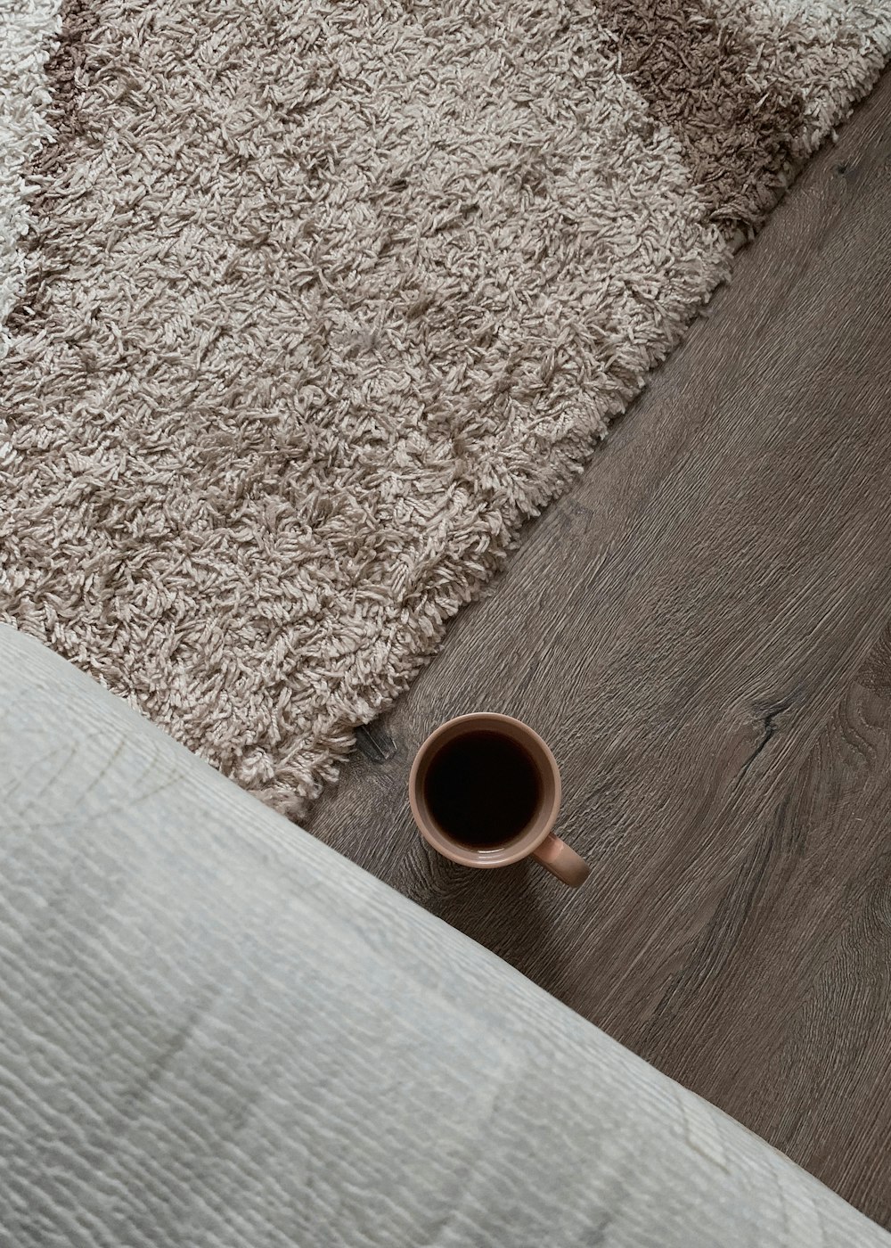 white ceramic mug on brown wooden table