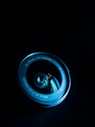 Close-up of a professional camera lens reflecting a cinematic set.