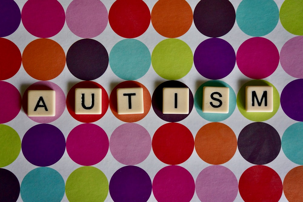 Autism on white tiles with colorful polka dot background