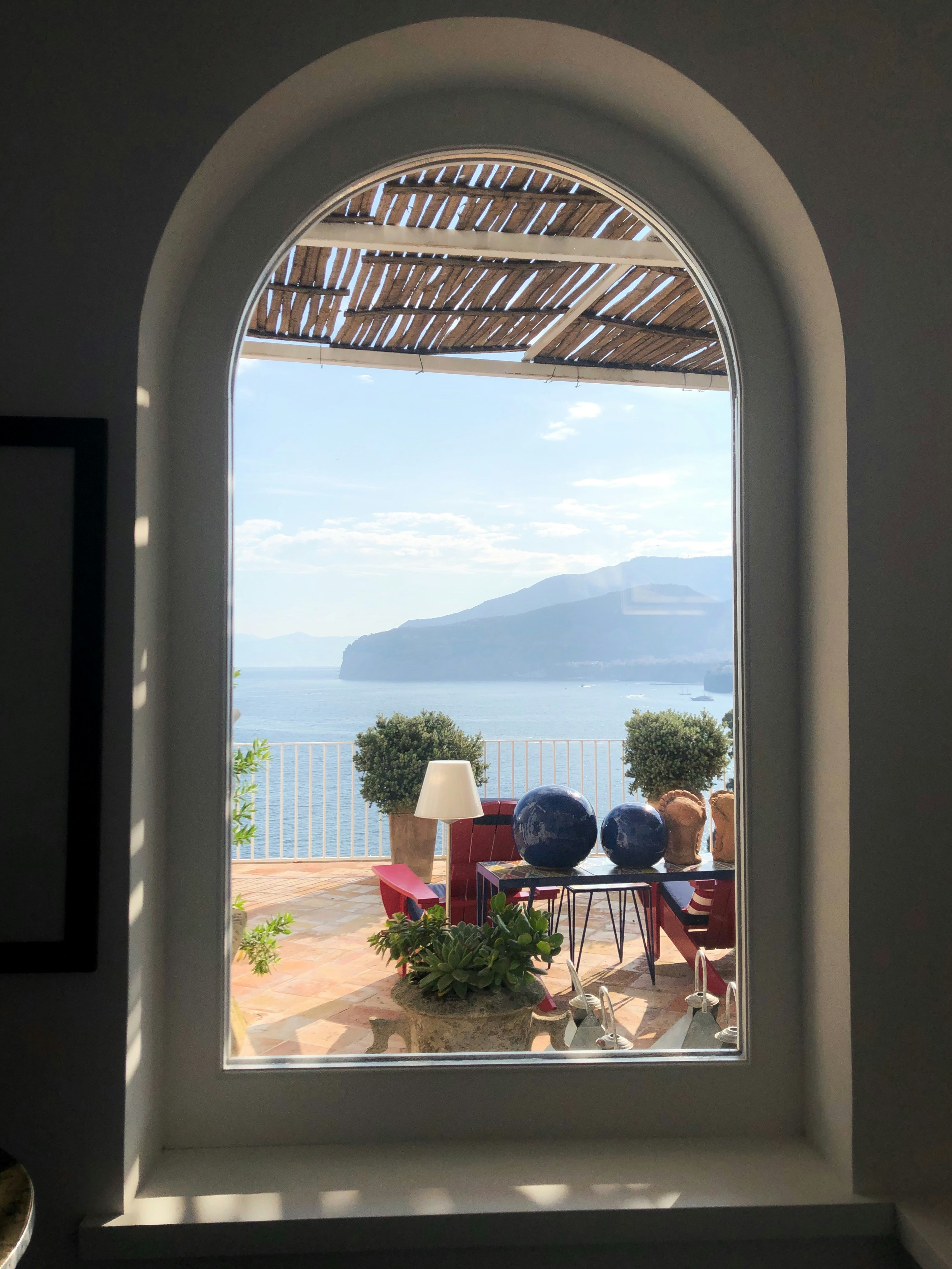 great photo recipe,how to photograph frame within a frame. the beautiful maison la minervetta sorrento italy.  ; 2 person sitting on chair near window during daytime