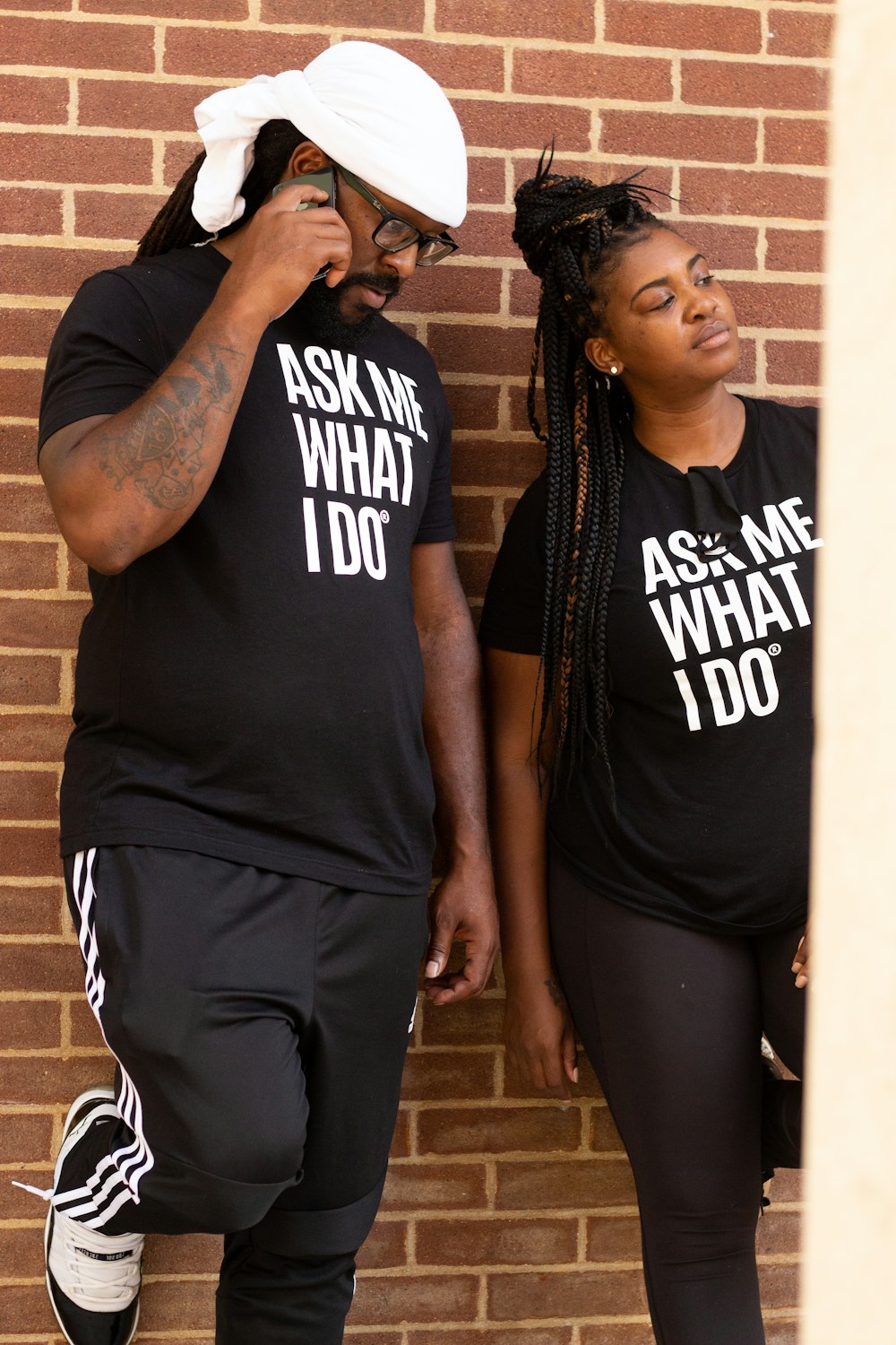 man in black and white tank top beside woman in black and white crew neck t