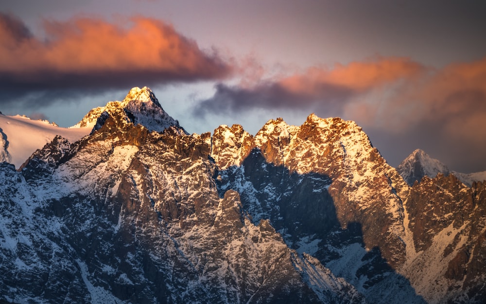 brown and white mountain under cloudy sky during daytime