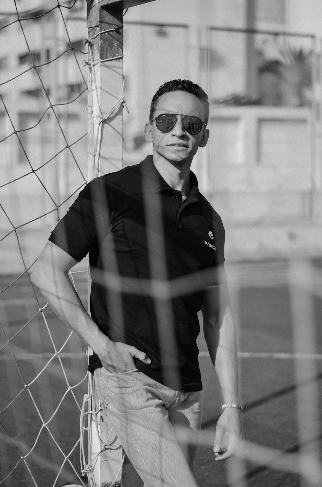 man in black polo shirt wearing sunglasses